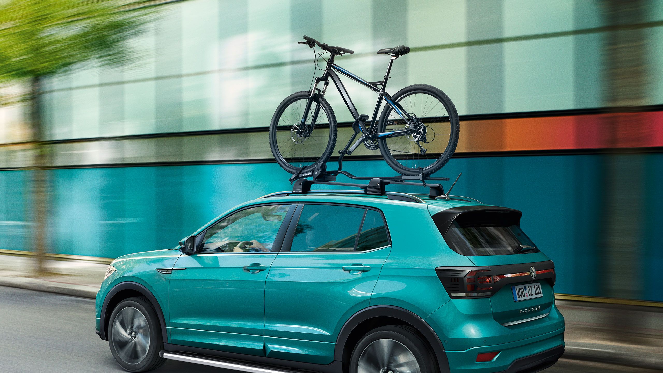 Um VW T-Roc turquesa com acessórios VW para ciclistas